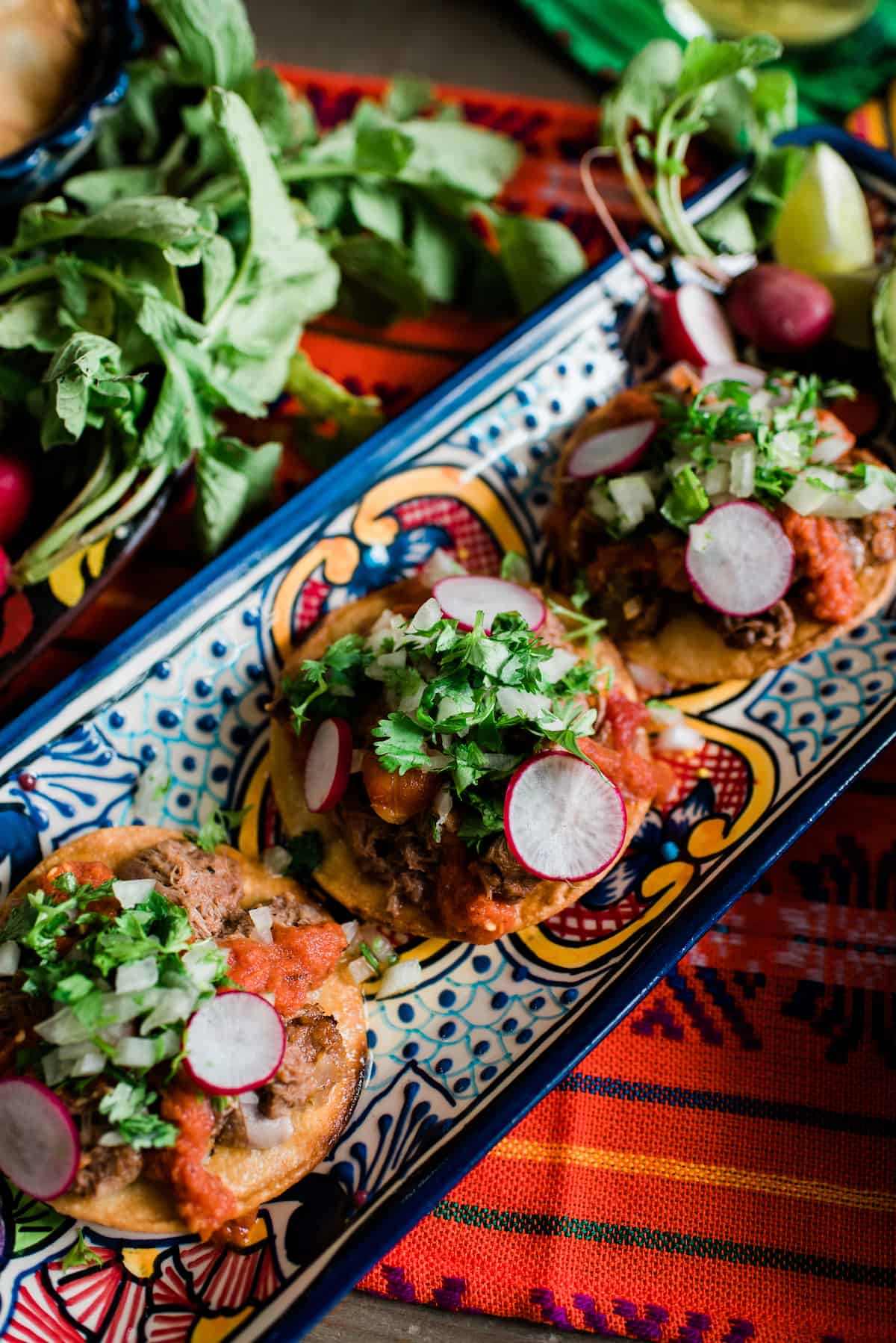 slow cooked lengua recipe served as tostadas de lengua on Mexican pottery traditional Mexican dish