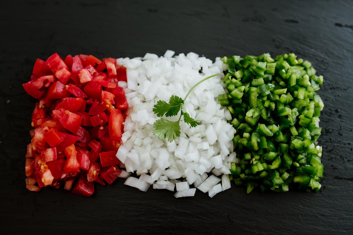 Mexican flag shaped with chopped tomatoes white onion and jalapeño 
