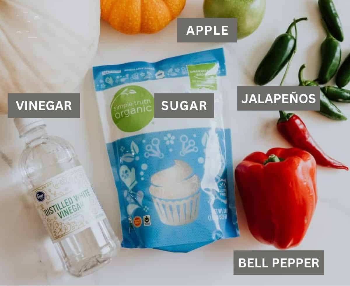 labeled ingredients for making apple jalapeno pepper jelly with no pectin laid out on a table.