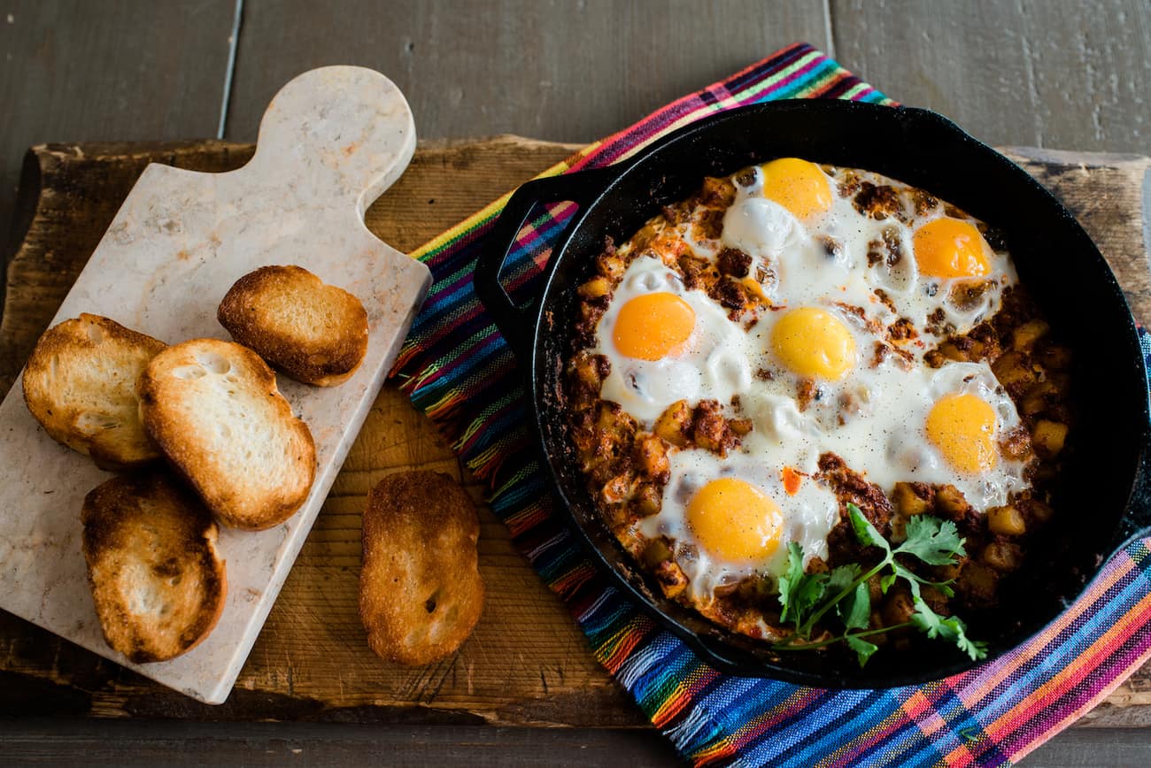 Baked Eggs with Chorizo and Potatoes and toasted bolillo slices.