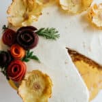 overhead shot of carrot cake decorated with dried pineapple flowers.