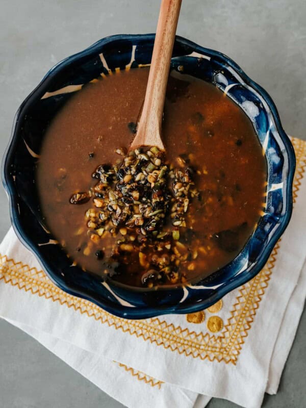 salsa macha in a blue bowl with a wooden spoon.