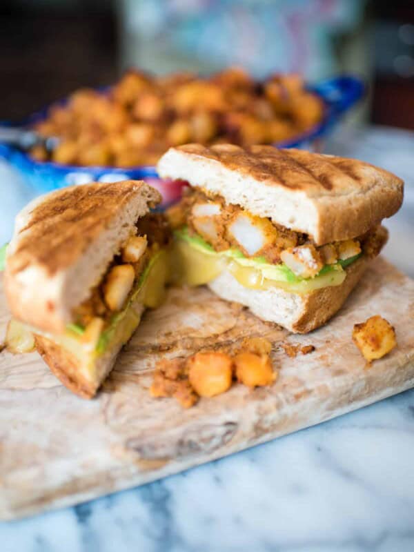 Breakfast Tortas with Potatoes and Chorizo cut open on a cutting board.