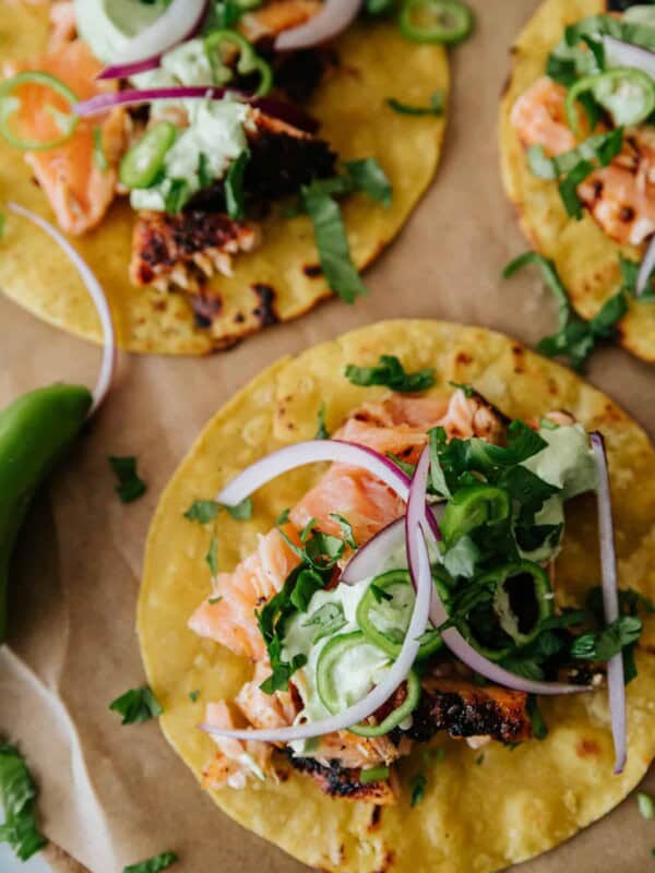 overhead shot of salmon fish taco on a parchment lined sheet tray.