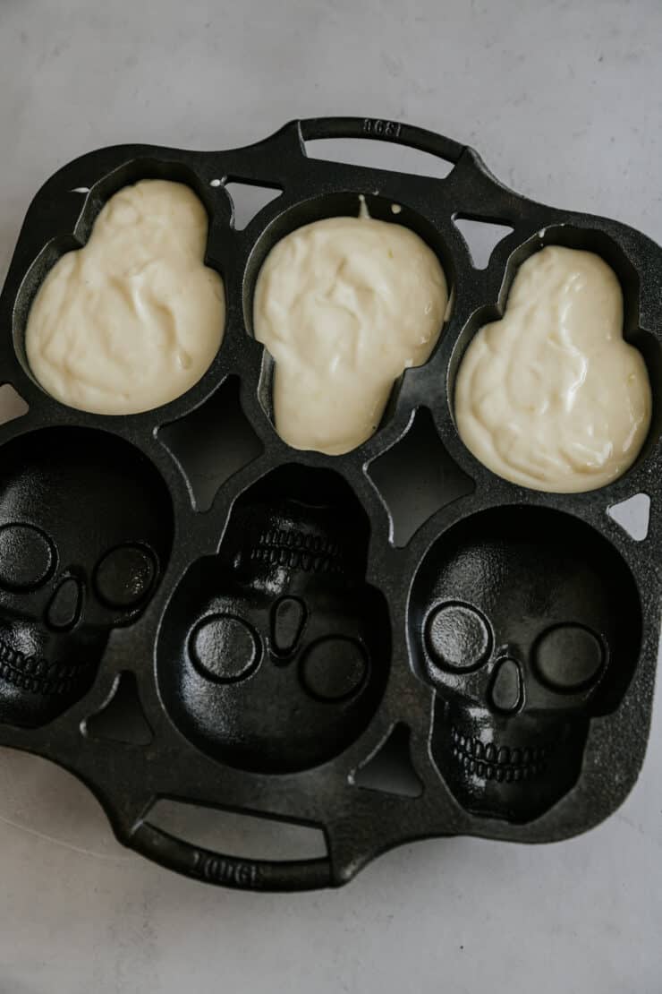 Lemon cake batter in a skull cake pan mold.