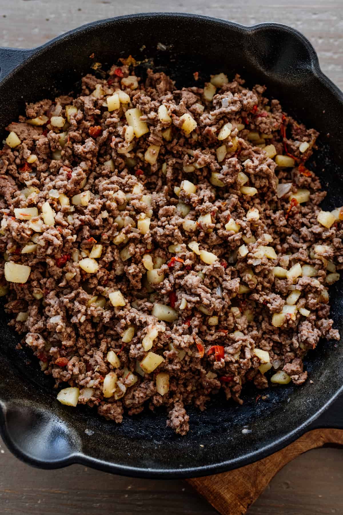 Mexican ground beef picadillo in a cast iron skillet.