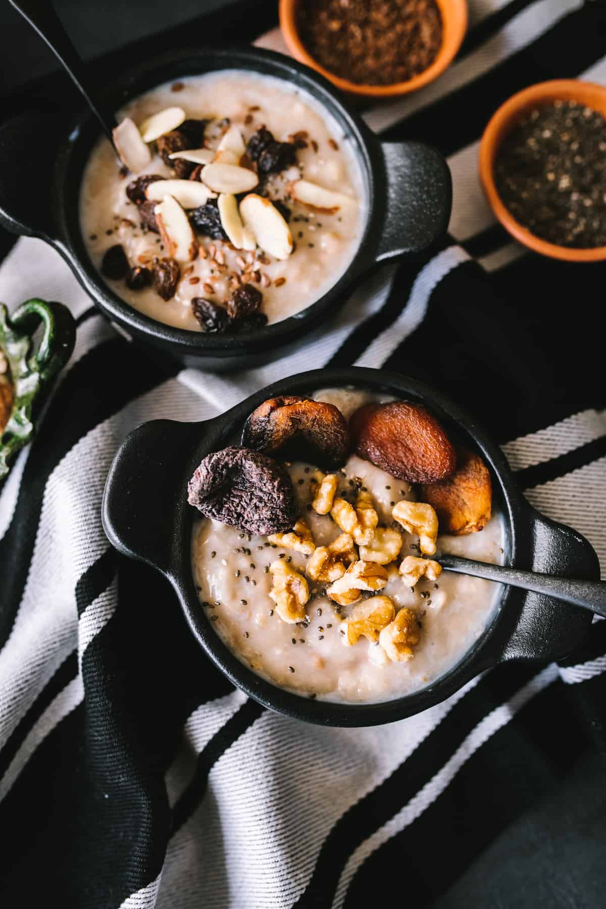 Slow Cooker Oatmeal in cast iron bowl garnished with dried fruits and nuts.