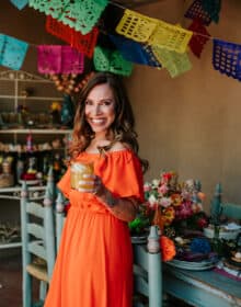 Yvette Marquez Sharpnack, latina food blogger, toasting the camera with a margarita.