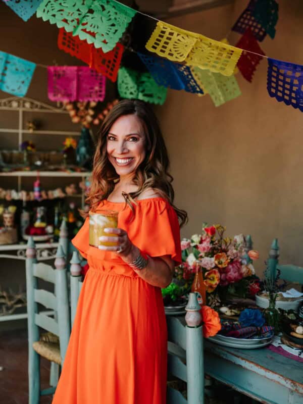 Yvette Marquez Sharpnack, latina food blogger, toasting the camera with a margarita.