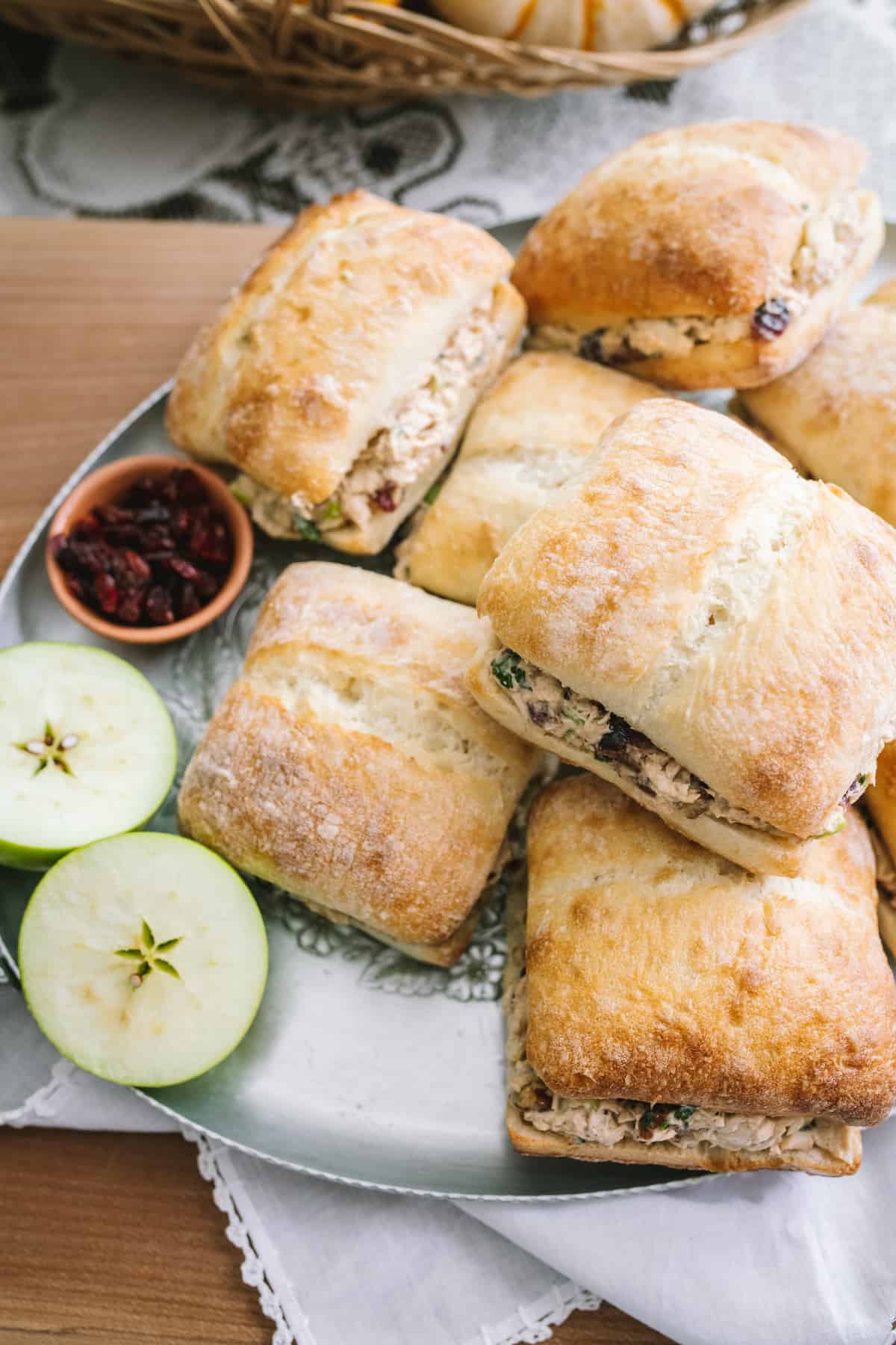 a platter of fall chicken salad sandwiches on ciabatta buns.