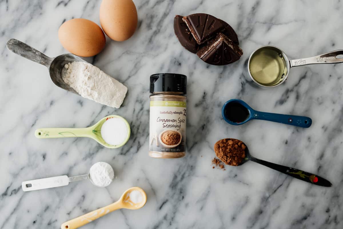 flour, eggs, leavening, salt, mexican chocolate, cocoa powder, cinnamon and vanilla as mis en place for Mexican Chocolate Crinkle Cookies recipe.