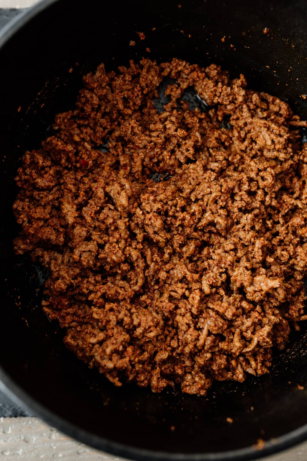 chorizo and ground beef mix browning in a dutch oven for chili con carne.
