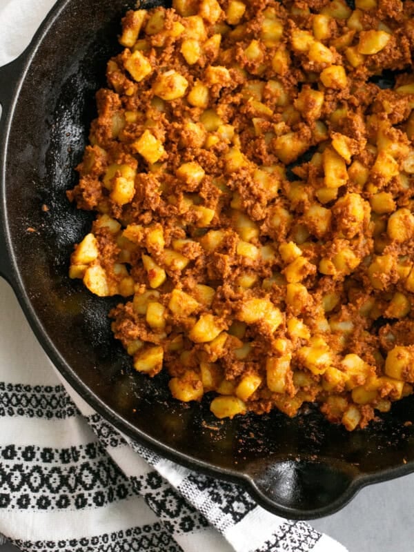 Overhead shot of papas con chorizo in a black skillet