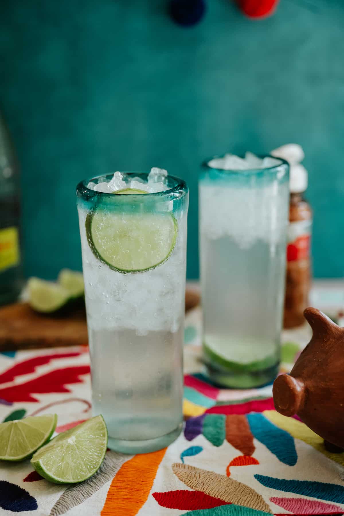 two tall collins glasses filled with homemade Texas ranch water and garnished with lime slices. 