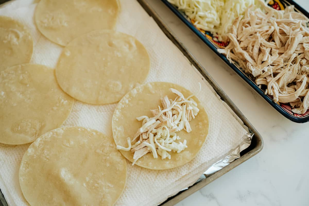 process shot — one of the fried tortillas with a line of cheese and poached chicken down the middle. 