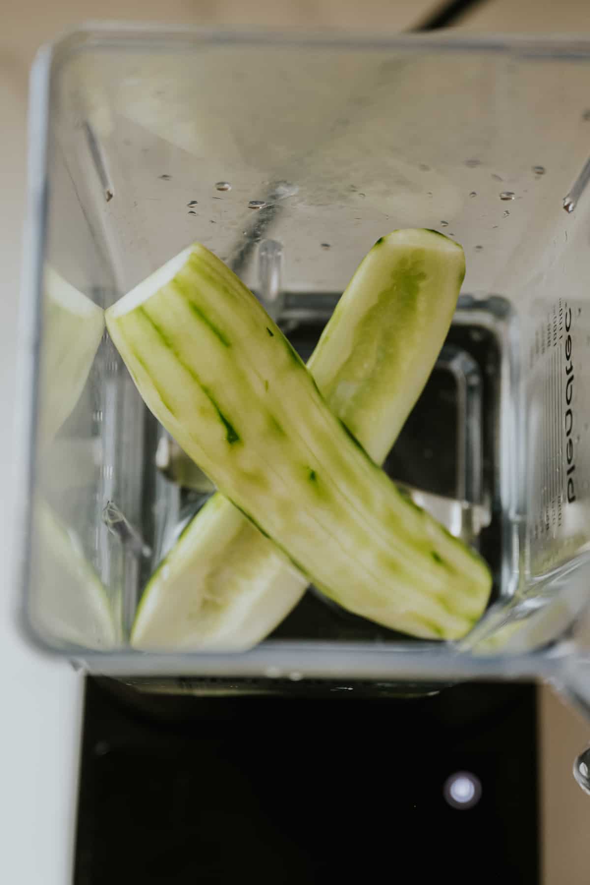 halved and peeled cucumber in the base of a blendtec pitcher with water. 