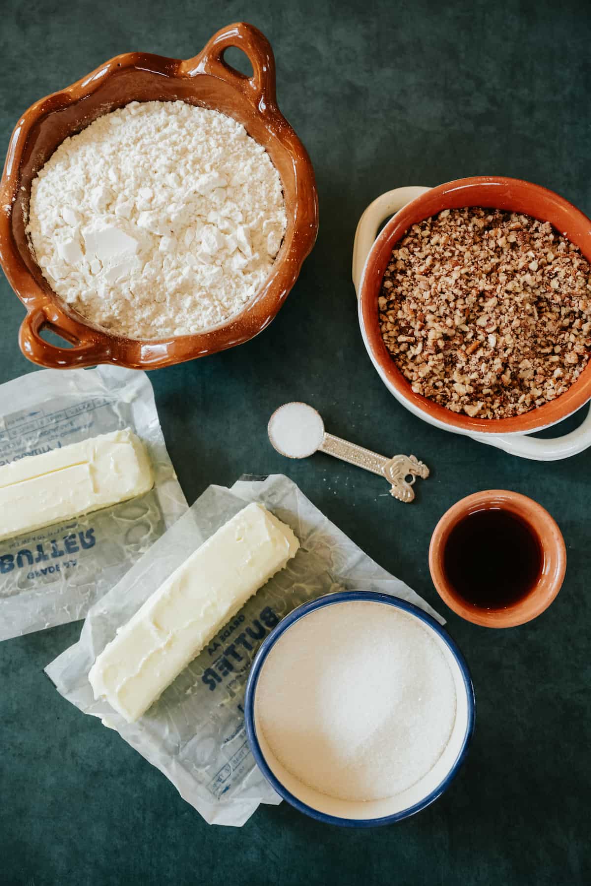 ingredients to make Polvorones Cookies (Mexican Wedding Cookies) - flour, pecans, butter, vanilla extract, salt, and sugar.