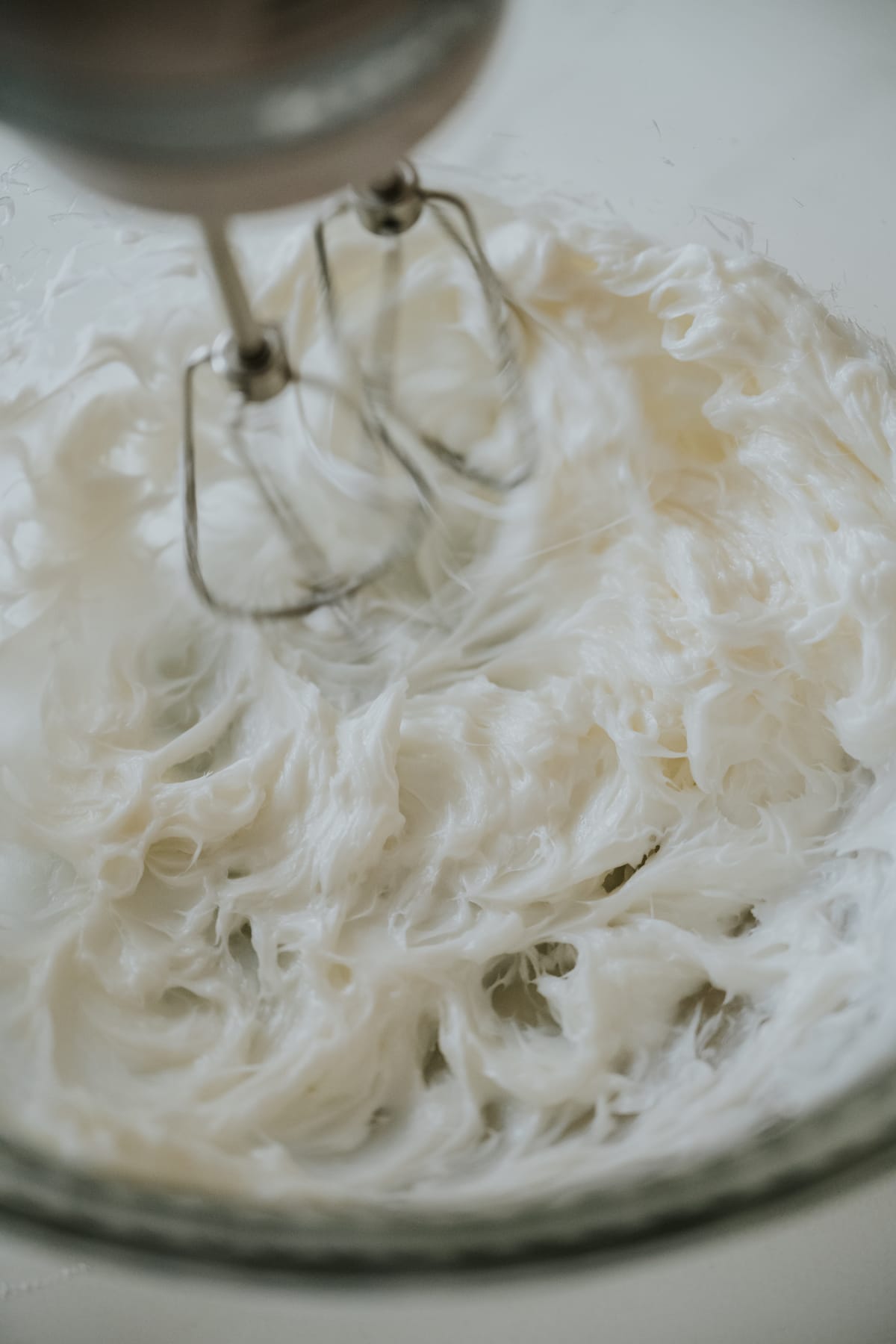 lard in a mixing bowl with an electric mixer, creaming it like butter.