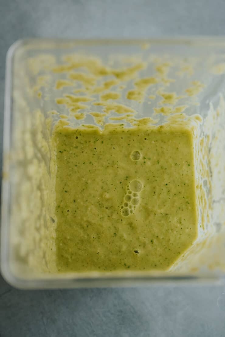 flat lay shot of green chilaquiles sauce blended in the base of a blender. 