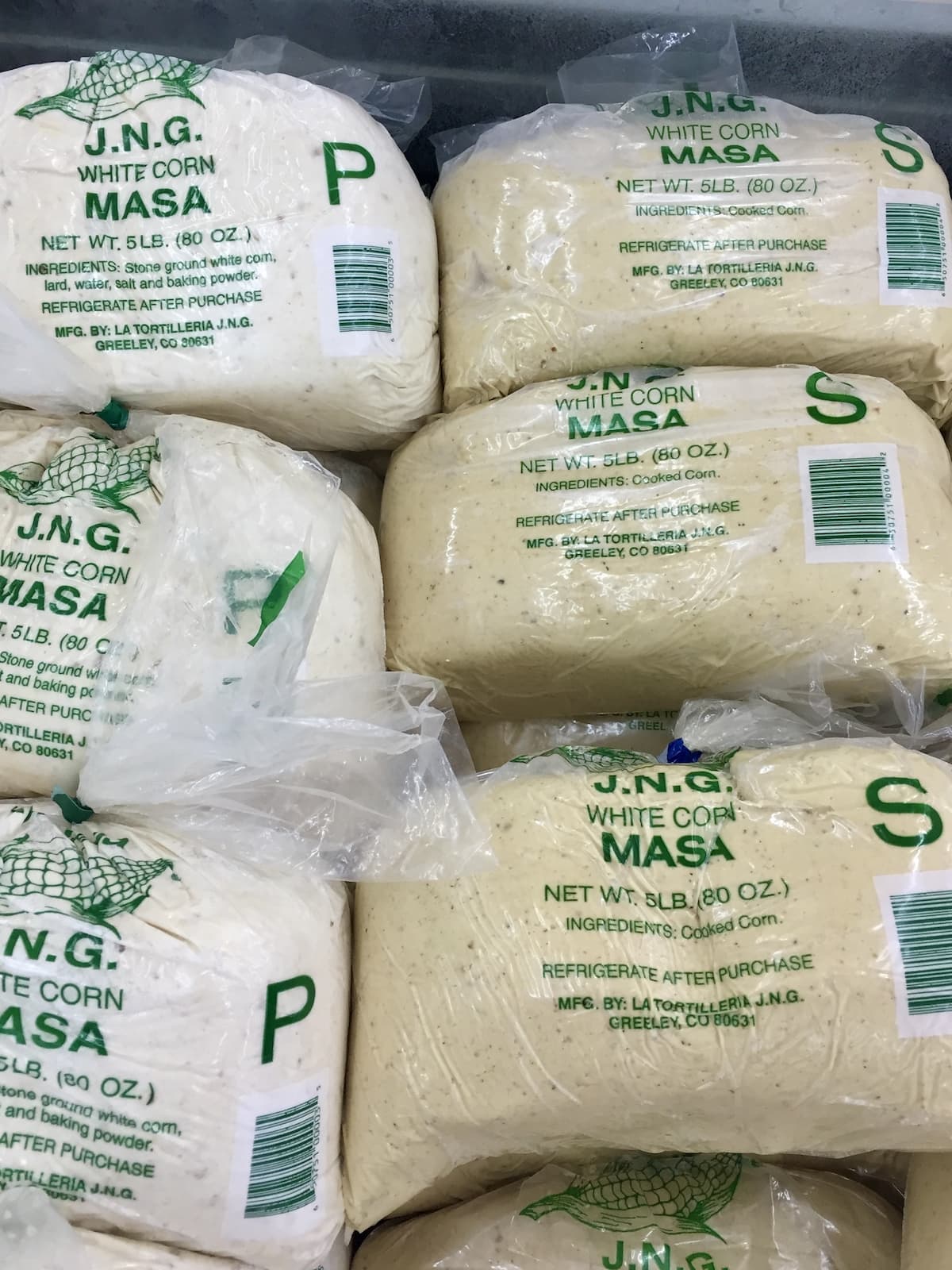 bags of prepared and unprepared fresh masa for tamales with prominent "S" and "P" marking for "sin preperar" and "preparada."