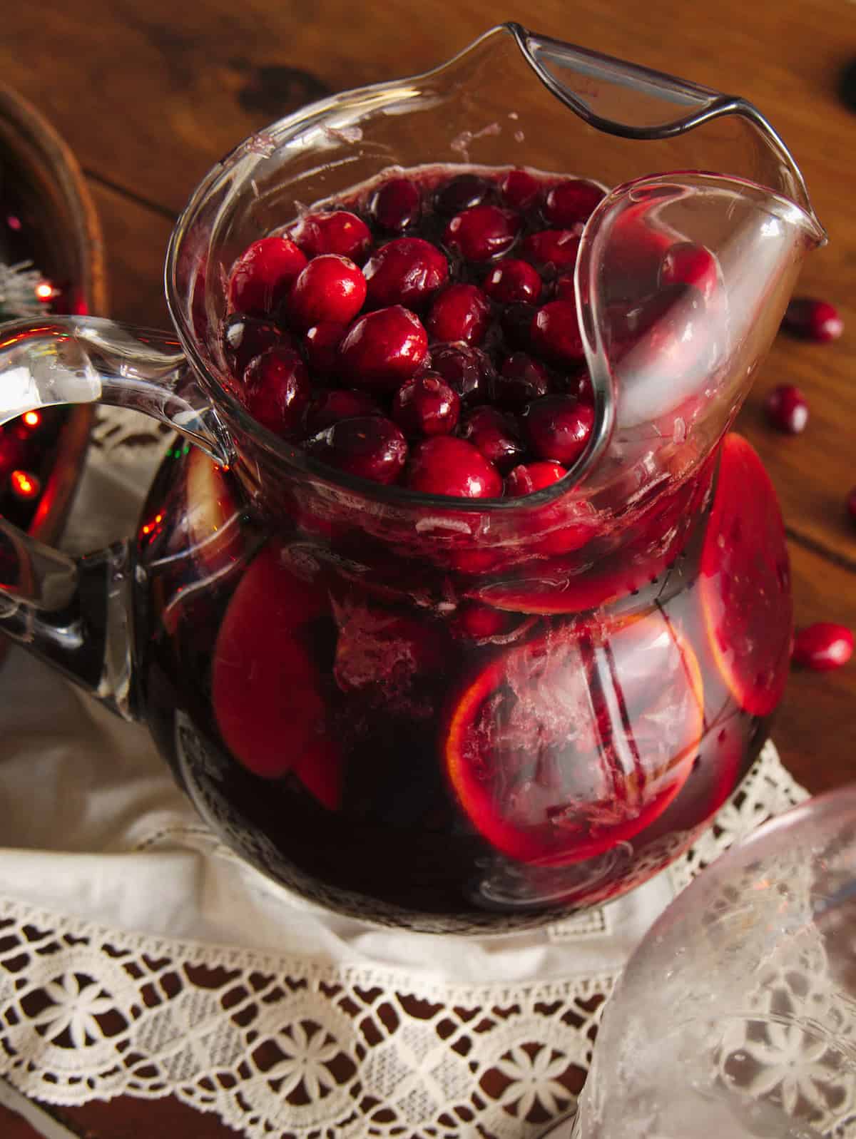 completed red holiday sangria after adding the club soda; with the 45 degree angle, you can see all the cranberries have floated to the top. 