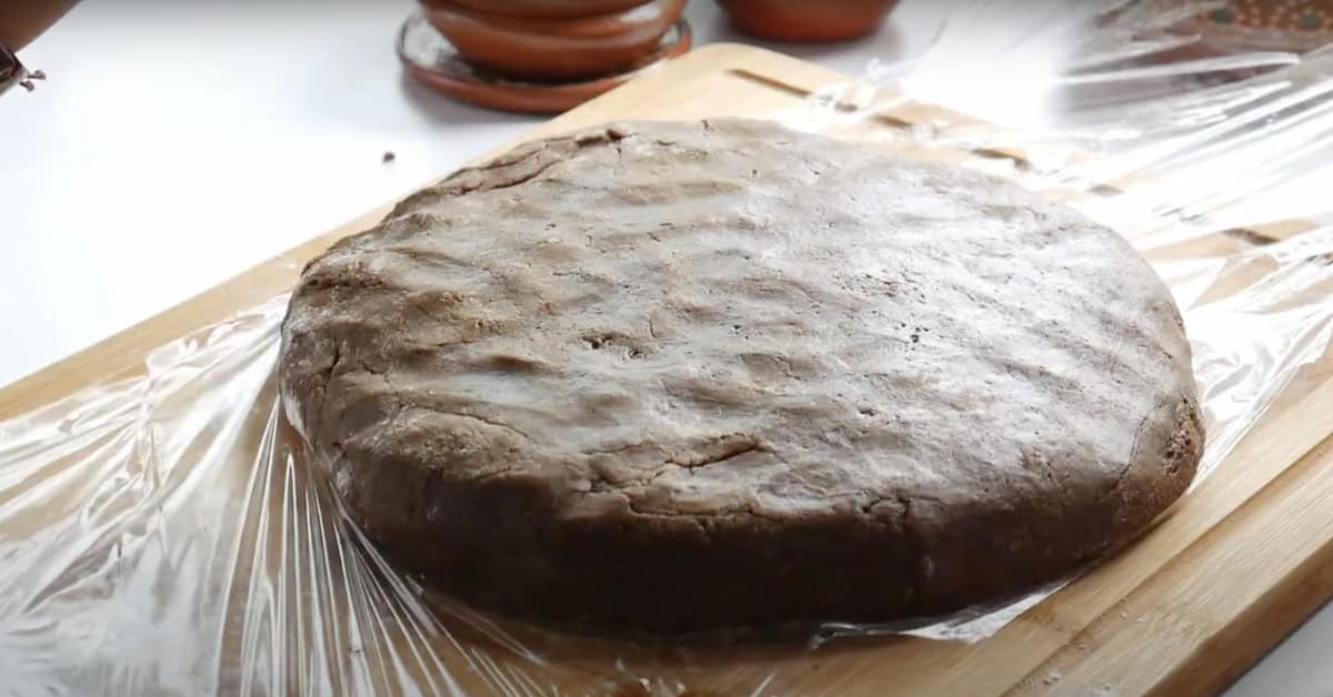 completed Mexican gingerbread dough in a giant disc about to be wrapped in plastic to chill. 