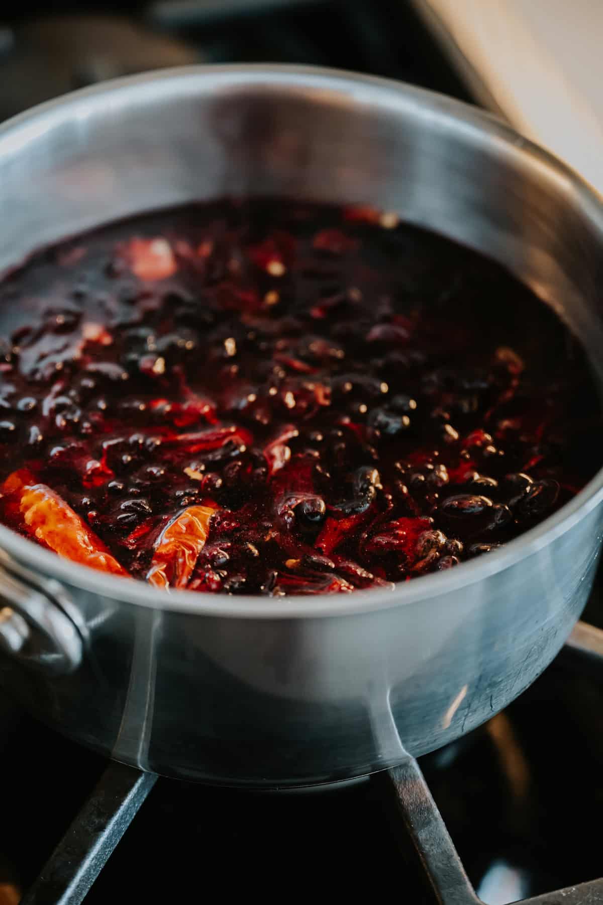 Homemade Mexican Chamoy Sauce simmering in a pot.
