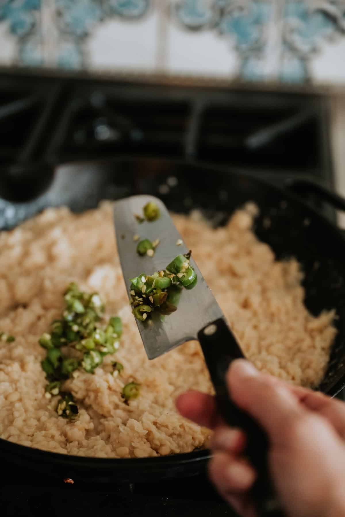 diced jalapeño added to the skillet with the cheesy refried bean dip. 