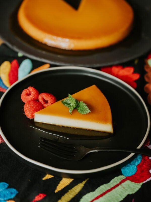 Whole baked Puerto Rican flan on a serving plate topped with glossy caramel.